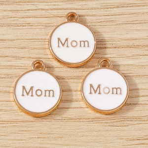 Detailed close-up of circular Mom charms with white enamel and golden alloy finish