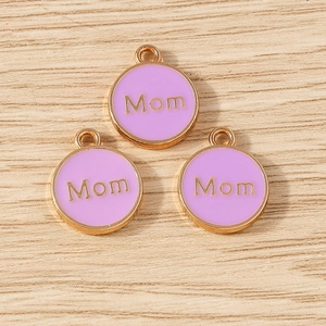 Detailed close-up of lavender enamel Mom charms with golden plating on wooden surface