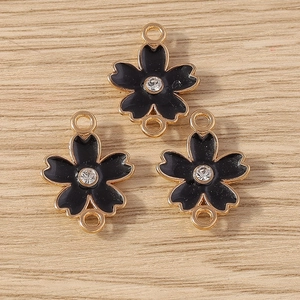 Detail of floral alloy connector with black enamel and crystal for DIY jewelry making
