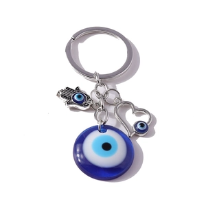 Evil Eye keychain featuring deep blue glass bead with heart and Hamsa Hand charms