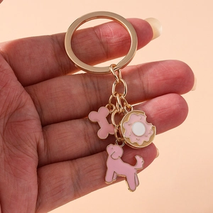 Pink enamel poodle dog bone and donut keychain in light gold plating for women