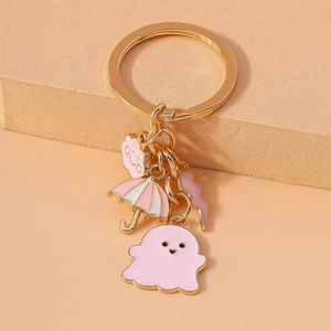 Cute gold keychain with pink ghost, umbrella, cloud and lightning charms for bags