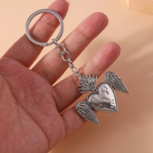 Vintage silver heart wing keychain with hammered texture and flame detail decoration