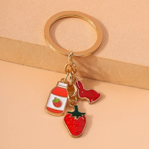 Mignon porte-clés doré avec charms lapin, pot de confiture et fraise en émail
