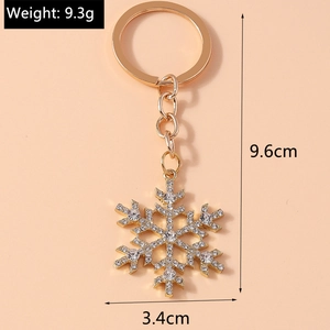 Detail view of snowflake keychain with gold alloy finish, rhinestones and dimensions