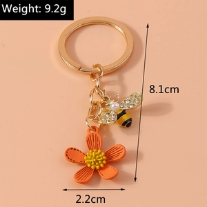 Detail view showing dimensions of a bee and flower keychain with rhinestones and pearl