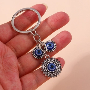 Retro hip-hop style evil eye keychain featuring three blue charms on a silver metal ring
