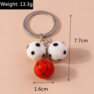 Detail view of soccer and basketball keychains with 13.3g weight and size measurements
