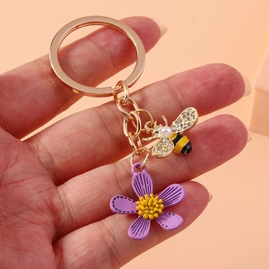 Cartoon honey bee and purple flower keychain with gold hardware and sparkling rhinestone wings