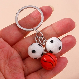 Detail of 3D football and basketball pendants on a chrome keychain ring for sports fans