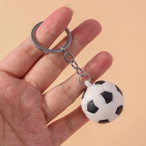 Close-up of a mini soccer ball keychain held in hand to show compact size and details