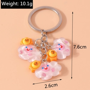 Vue détaillée d'un porte-clés avec breloques soleil et nuage nacrés et détails de taille
