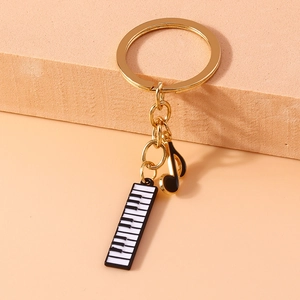 Fashionable music-themed keychain featuring piano keys and black musical note pendants