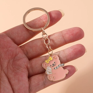 Pink cartoon bear keychain with ice cream charm and rose gold link chain detail