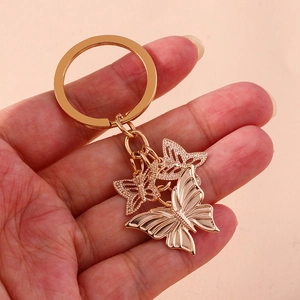 Fashion alloy butterfly keychain accessory in rose gold with hollow and solid charms