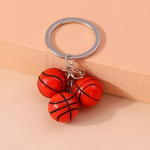 Detailed view of red basketball keychain with three mini pendants and silver metal ring