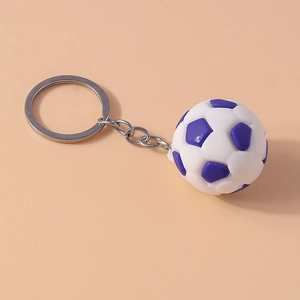 Detail of a mini white and purple soccer ball keychain with a polished metal split ring