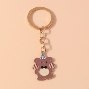 Cute brown cartoon bear keychain with party hat and red balloons in a gift style