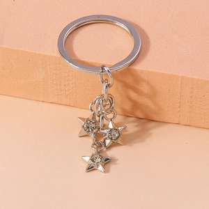 Detailed view of silver star keychain charms with sparkling white rhinestones on a ring