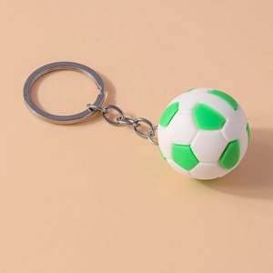 Detailed close-up of white and green soccer ball keychain with silver metal ring