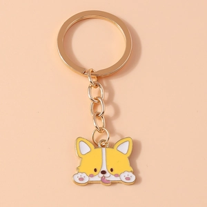 Detailed view of yellow cartoon Corgi keychain with gold hardware and enamel finish
