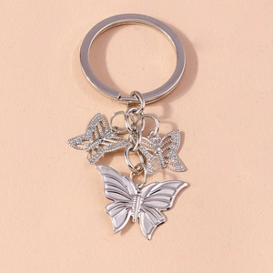 Detail of silver alloy butterfly keychains with solid embossed and hollow mesh charms