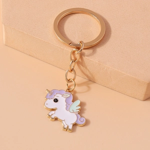 Detailed view of unicorn keychain featuring golden ring and pastel enamel unicorn charm