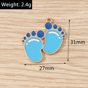 Macro detail of blue enamel baby footprint pendants with dimensions 31mm by 27mm