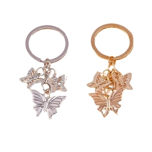 Set of two stylish metal butterfly keychains in gold and silver finish with charms