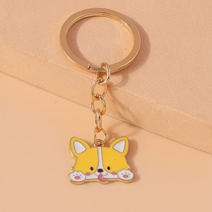 Detailed view of a cute cartoon Corgi keychain with yellow and white enamel finish