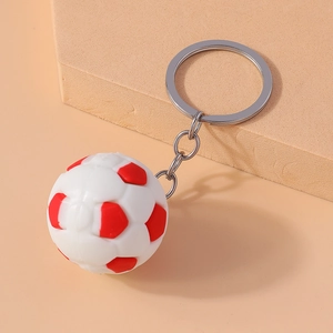 Detailed close-up of a red and white soccer ball keychain with silver metal ring