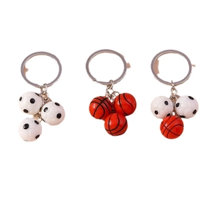 Three football and basketball keychains with 3D sports ball pendants on a white background