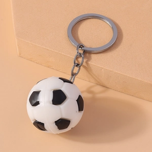 Detailed close-up of a realistic black and white soccer ball keychain with silver ring