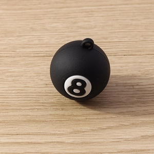 Close-up of black resin number 8 billiard ball pendant for DIY jewelry making