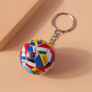 Close-up of a creative football keychain featuring various national flag patterns and silver ring
