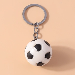 Detail of a classic black and white football keychain with secure silver metal ring