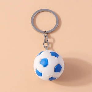 Macro detail of a white and blue mini football keychain with silver metal ring