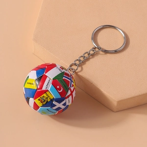 Detailed view of a football keychain featuring world flags on a beige tiered stand