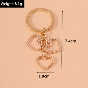Detail of gold hollow heart keychain showing weight 8.1g and height 7.4cm dimensions