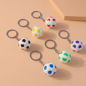 Close-up of 6 colorful football keychains in red, yellow, black, blue and green on orange background