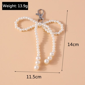 Detail showing pearl bow keychain dimensions 14cm by 11.5cm with metal clasp and 13.9g weight
