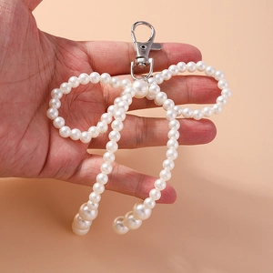 Romantic pearl beaded bow keychain accessory for handbags and elegant outfits