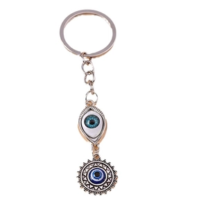 Hip hop evil eye keychain with solar pattern pendants on a clean white background
