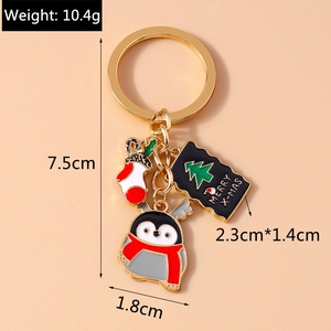 Detail of Christmas keychain with penguin, stocking and Merry X-mas tag charms