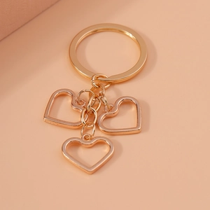 Minimalist gold heart-shaped hollow pendant keychain with three interlocking heart charms
