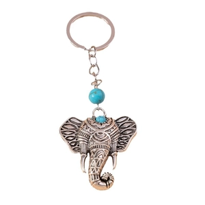 Vintage elephant keychain with turquoise beads and intricate alloy engraving on white base
