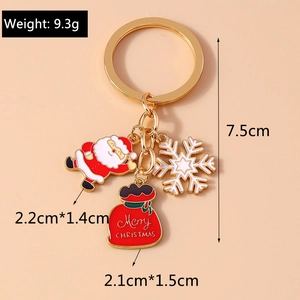 Detailed view of Christmas keychain with Santa charm and Merry Christmas gift bag tag