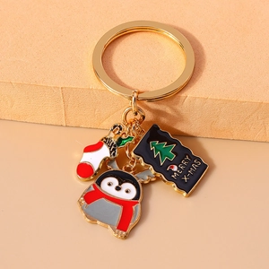 Creative Christmas keychain with penguin and sock charms in gold-toned metal alloy