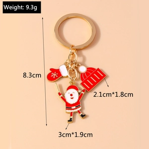 Detail view of a golden Christmas keychain with Santa charms showing 8.3cm total length