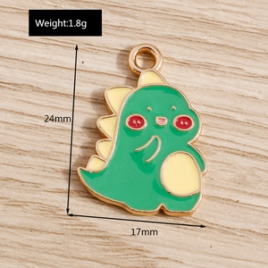 Detail view of a green dinosaur enamel charm with measurements 24mm height and 1.8g weight